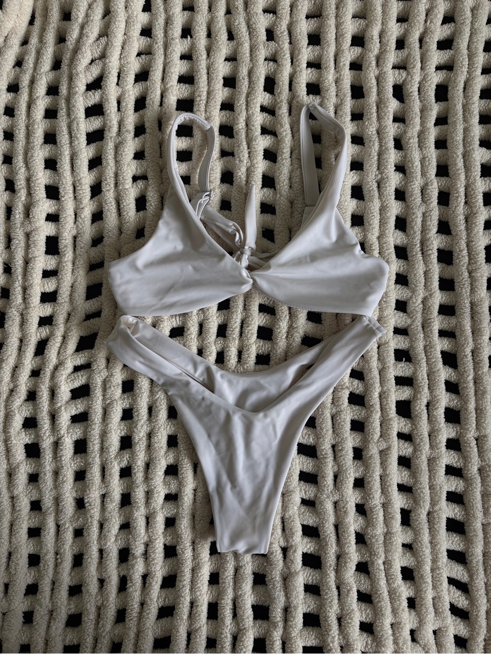 White bikini set with a simple triangle top and high-cut bottoms